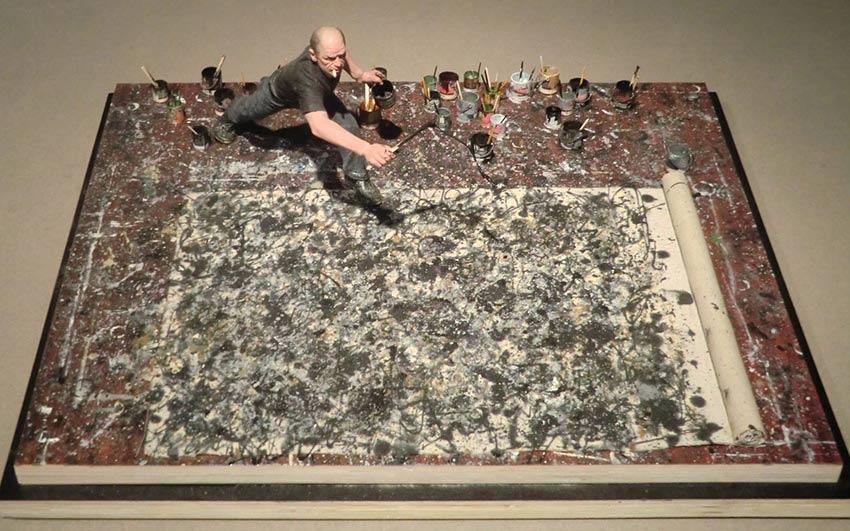 Here is a picture of American artist Jackson Pollock at work, dripping black paint onto an unprimed canvas. He is considered one of the most famous abstract expressionist painters of the 20th century.