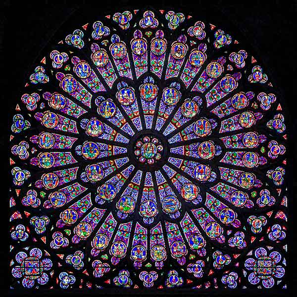North rose window of Notre Dame Cathedral in Paris, created around 1250, featuring intricate stained glass design.